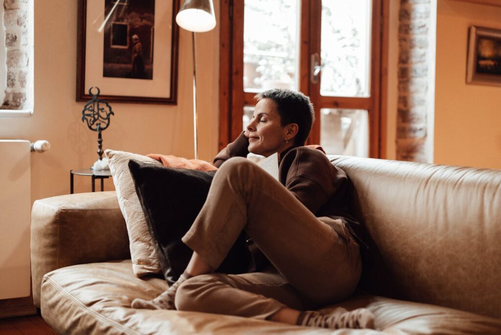 person sitting couch living room calm