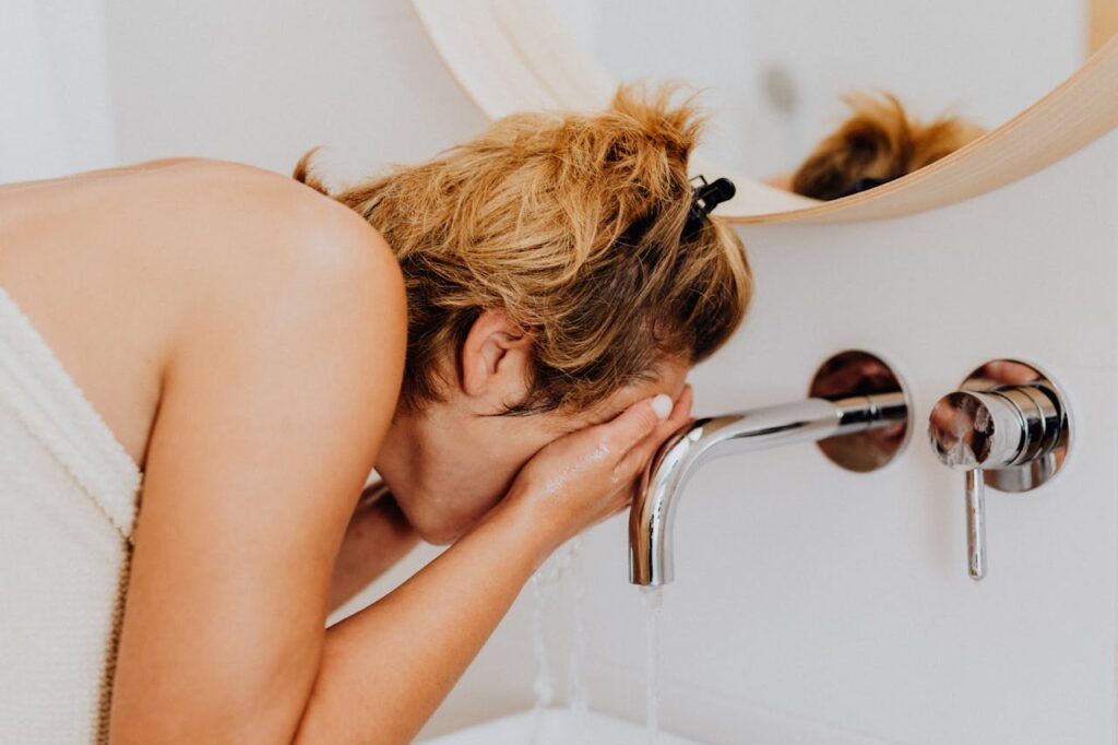 splashing cold water face bathroom