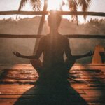 person meditating sitting chair sunlight