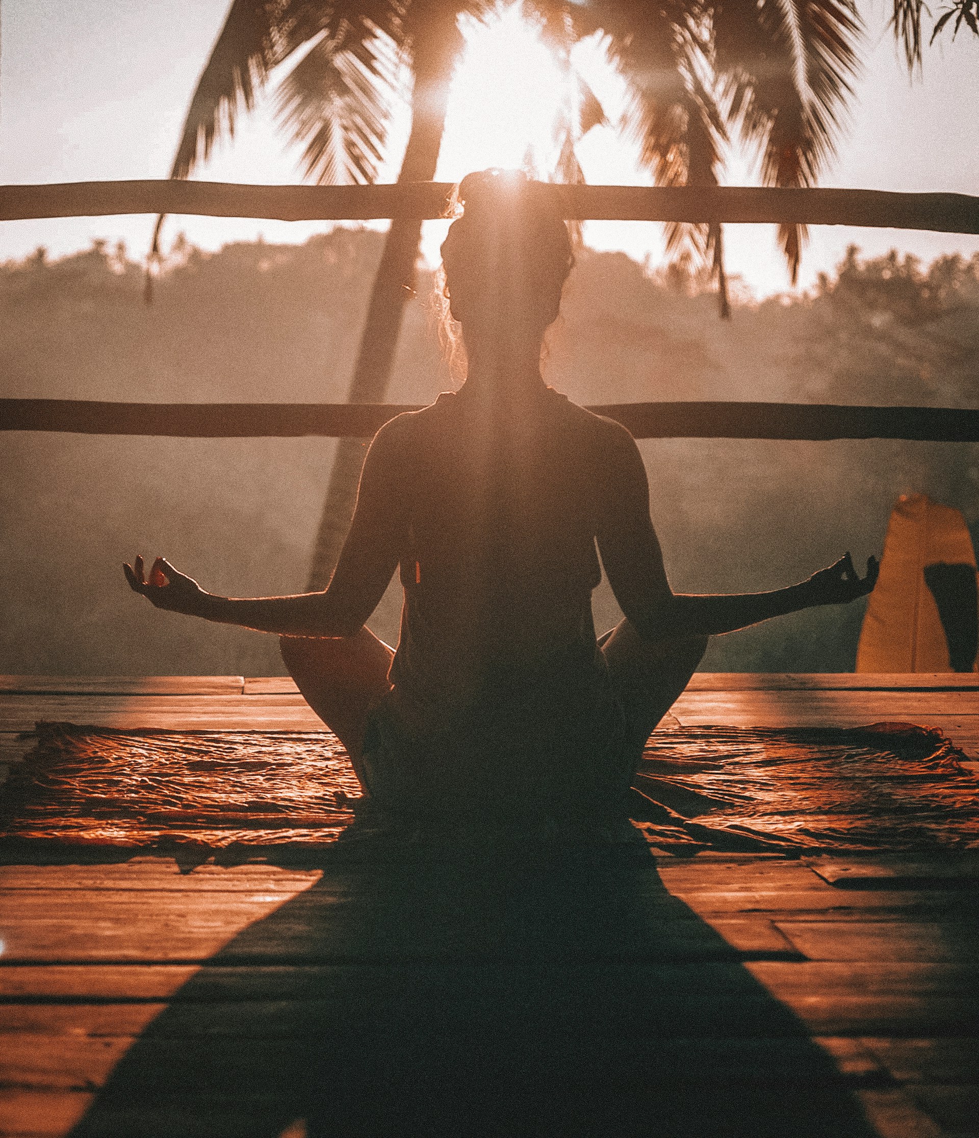 person meditating sitting chair sunlight