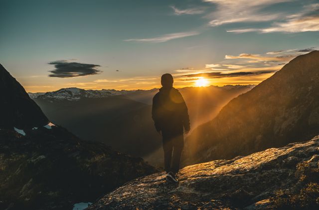 person standing sunrise mountain