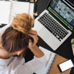 overwhelmed person at desk laptop