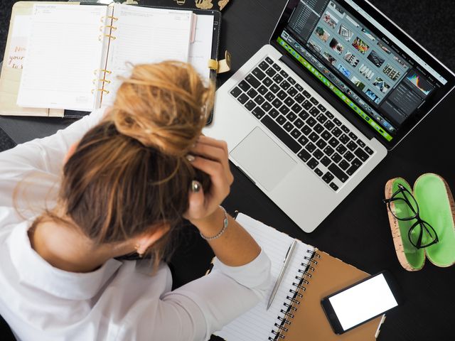 overwhelmed person at desk laptop