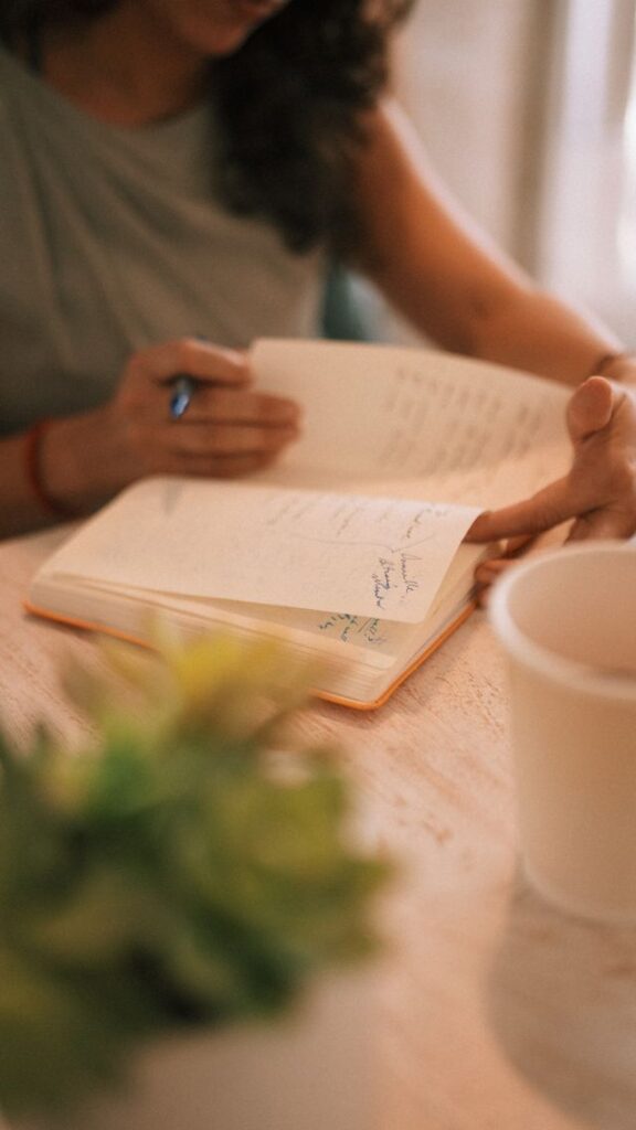 writing in journal morning sunlight desk