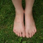 feet grounded on grass nature