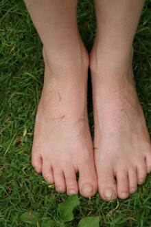 feet grounded on grass nature