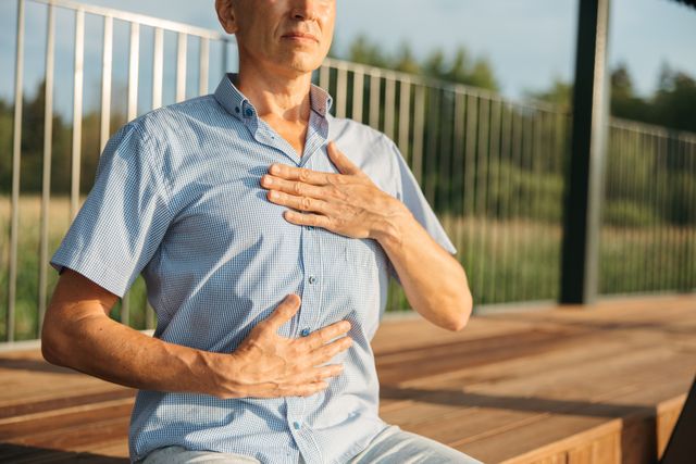 person hand on heart deep breath