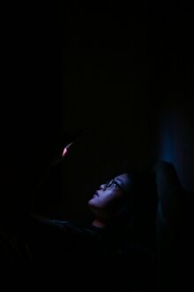 person anxious phone dark room